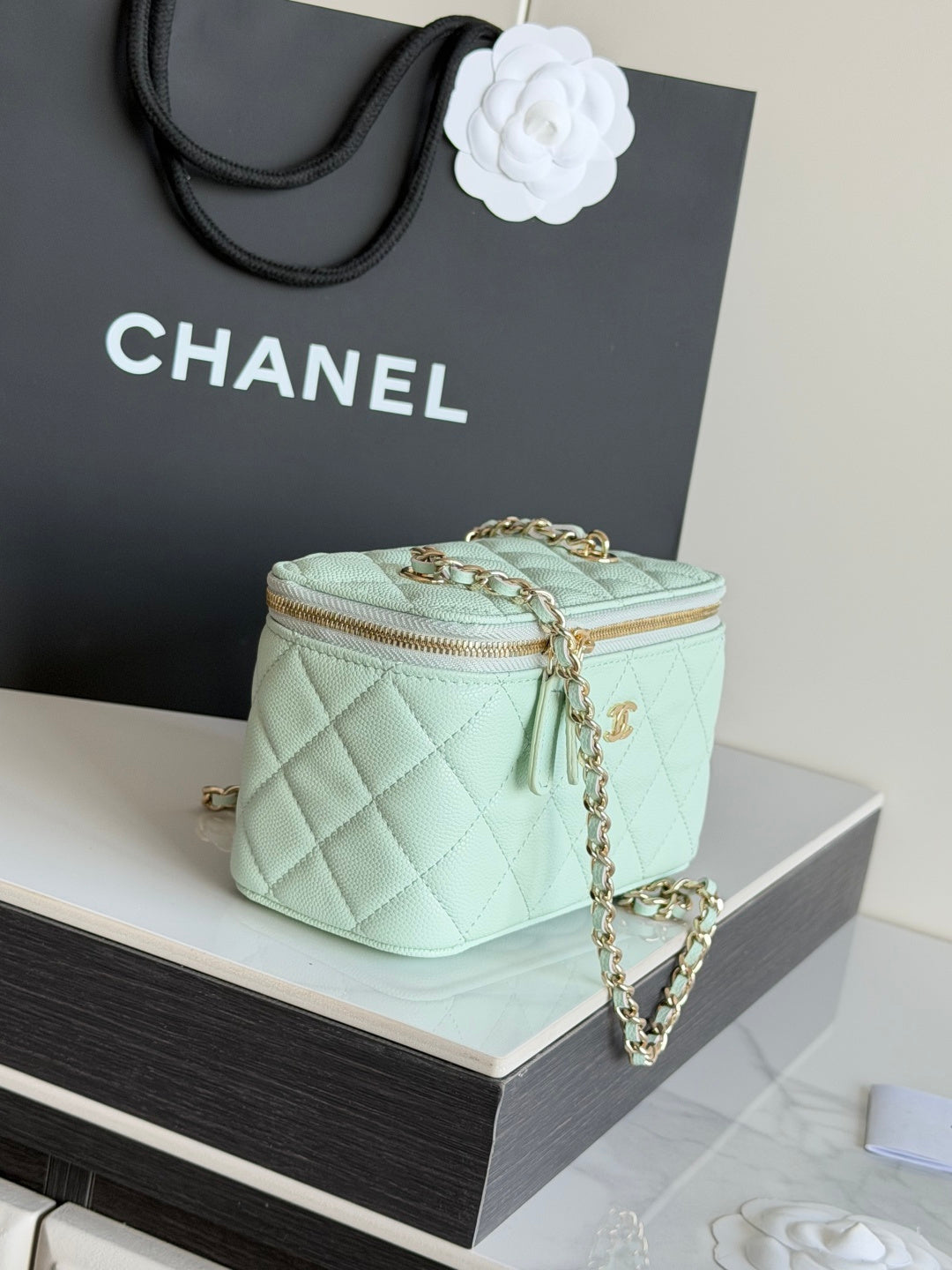Mint quilted small shoulder bag with top zip and long chain strap