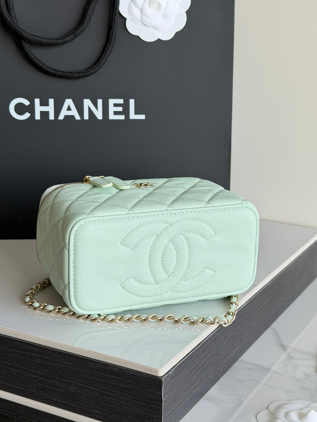 Mint quilted small crossbody bag with embossed CC logo on front and chain strap