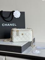 White quilted Chanel mini crossbody bag with gold chain and zip closure