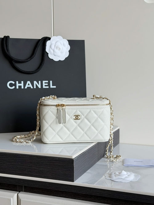White quilted Chanel mini crossbody bag with gold chain and zip closure