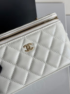 Chanel bag quilted white leather with gold CC logo, zip closure, and front panel