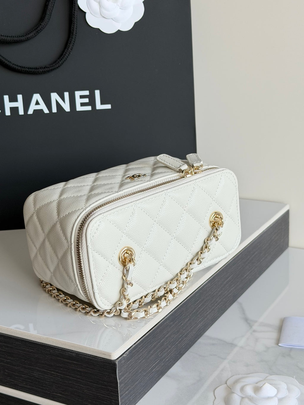 White Chanel quilted mini bag with gold chain strap and front logo hardware