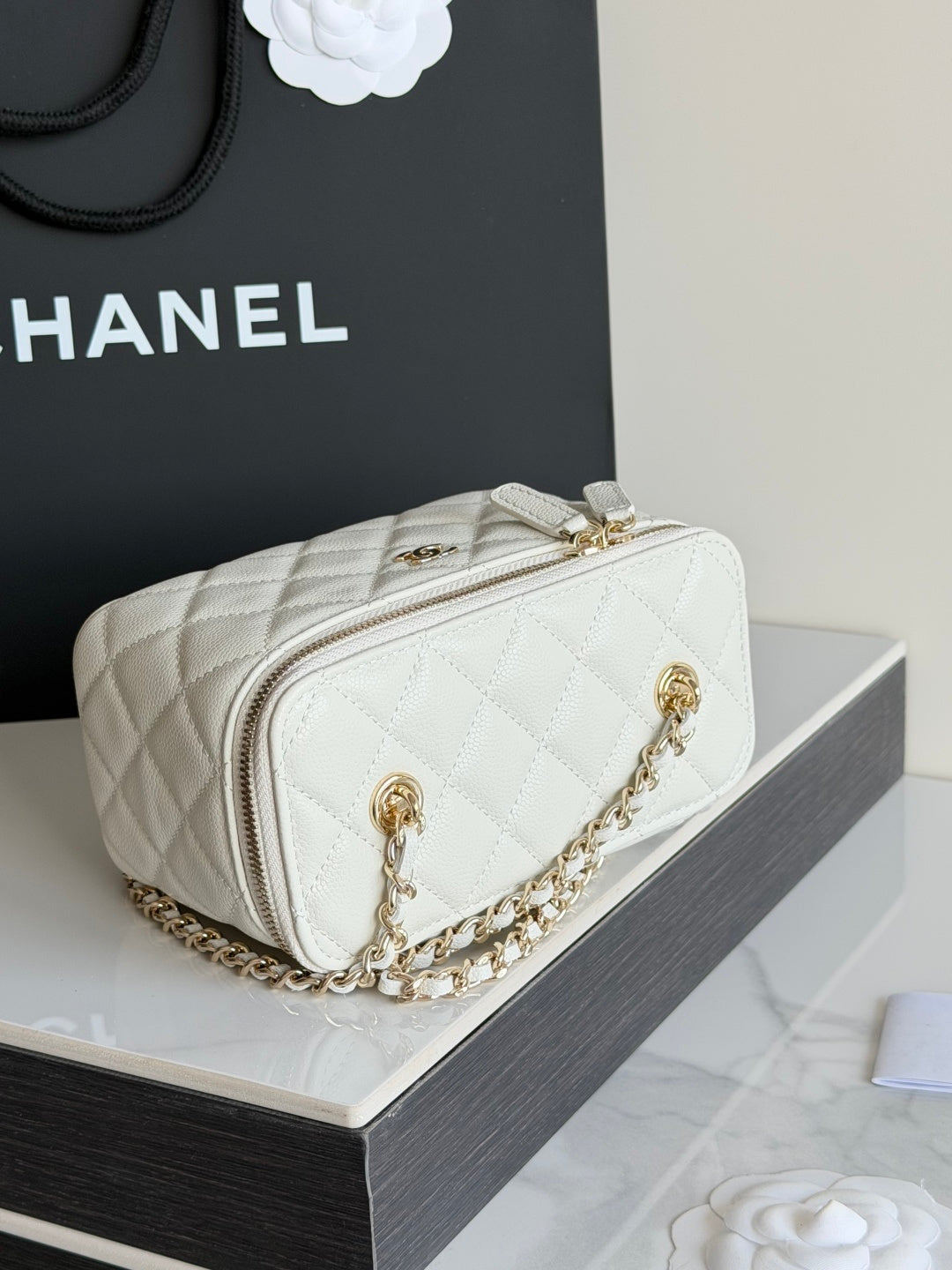 White Chanel quilted mini bag with gold chain strap and front logo hardware