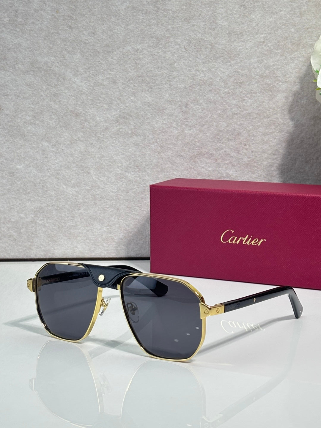 Cartier gold aviator sunglasses with dark blue lenses and clear temples