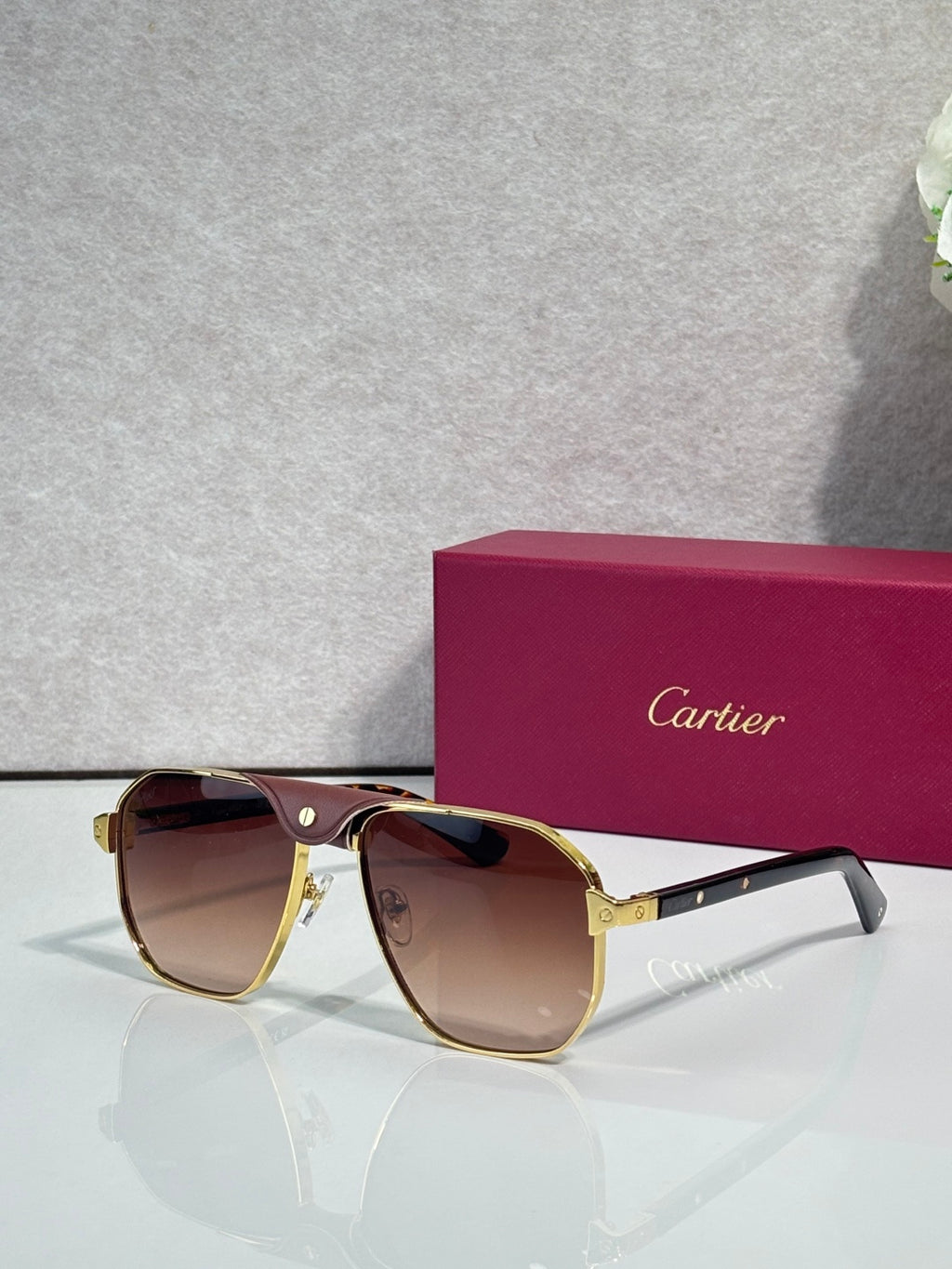 Cartier gold aviator sunglasses with amber lenses and dark temples