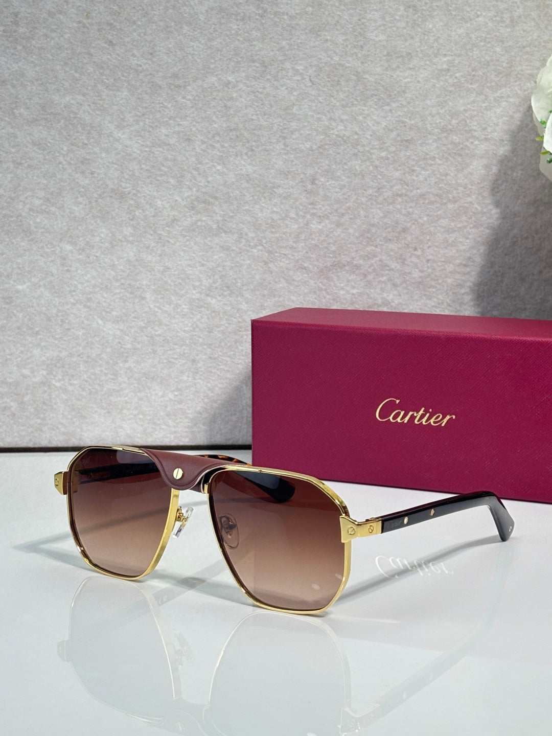 Cartier gold aviator sunglasses with amber lenses and dark temples