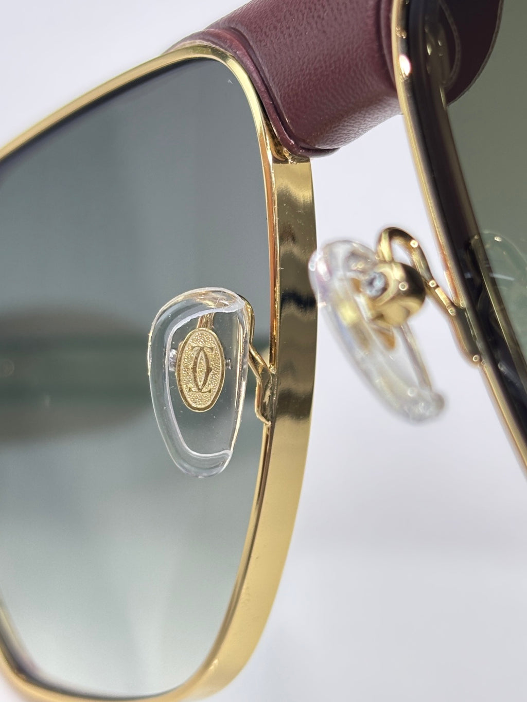 Cartier gold sunglasses hinge detail with brown leather temple trim