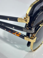 Cartier gold sunglasses temple hinge with engraved logo and dark lenses