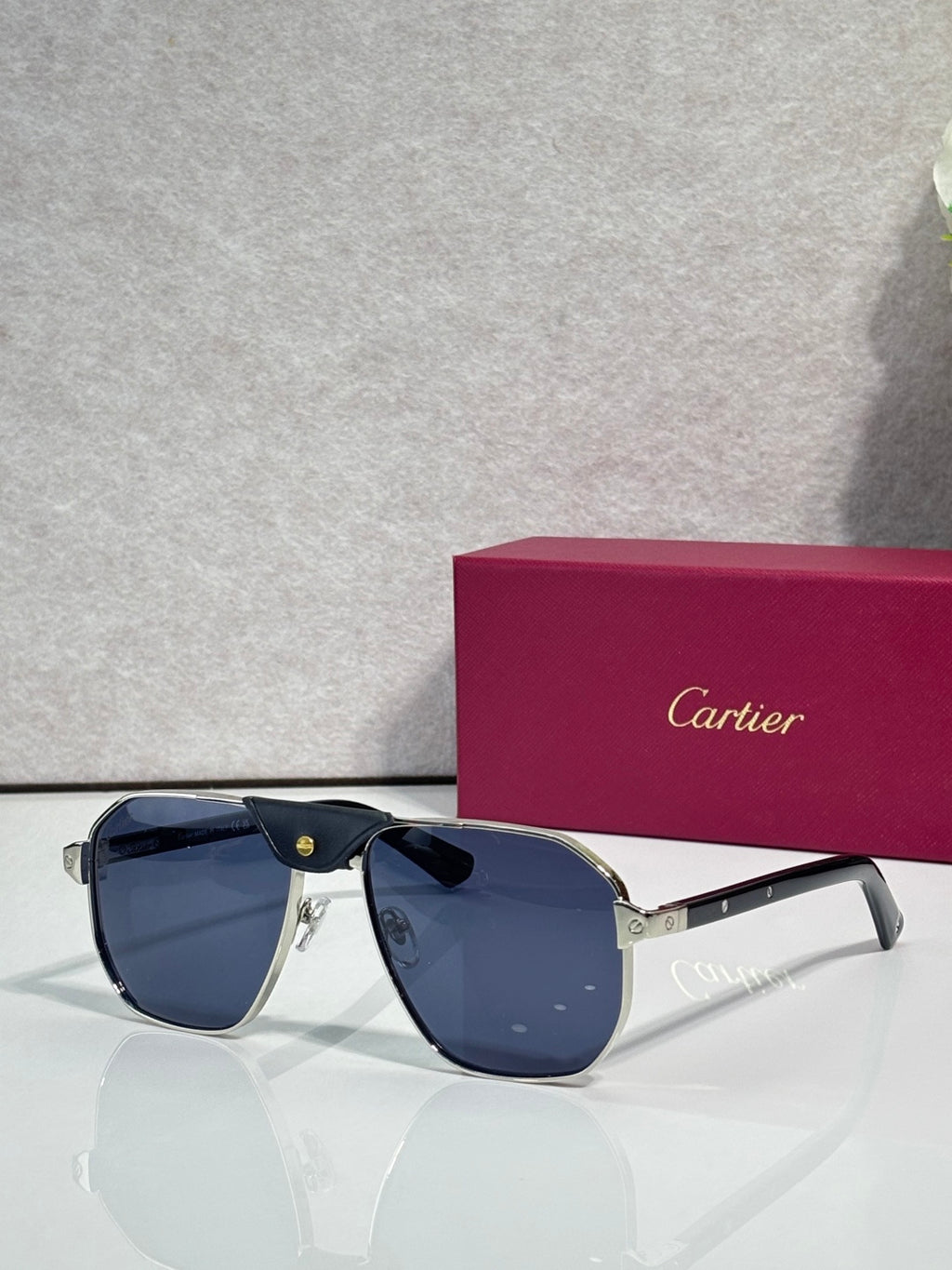 Cartier navy aviator sunglasses with dark blue lenses and gold details