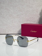Gold-framed sunglasses with gray-green tinted lenses and sleek temple arms
