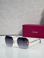 Gold-framed sunglasses with deep blue tinted lenses and curved shield frame