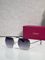 Gold-framed sunglasses with dark blue tinted lenses and polished metal arms