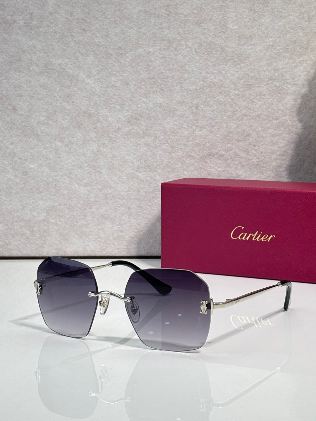 Gold-framed sunglasses with dark blue tinted lenses and polished metal arms