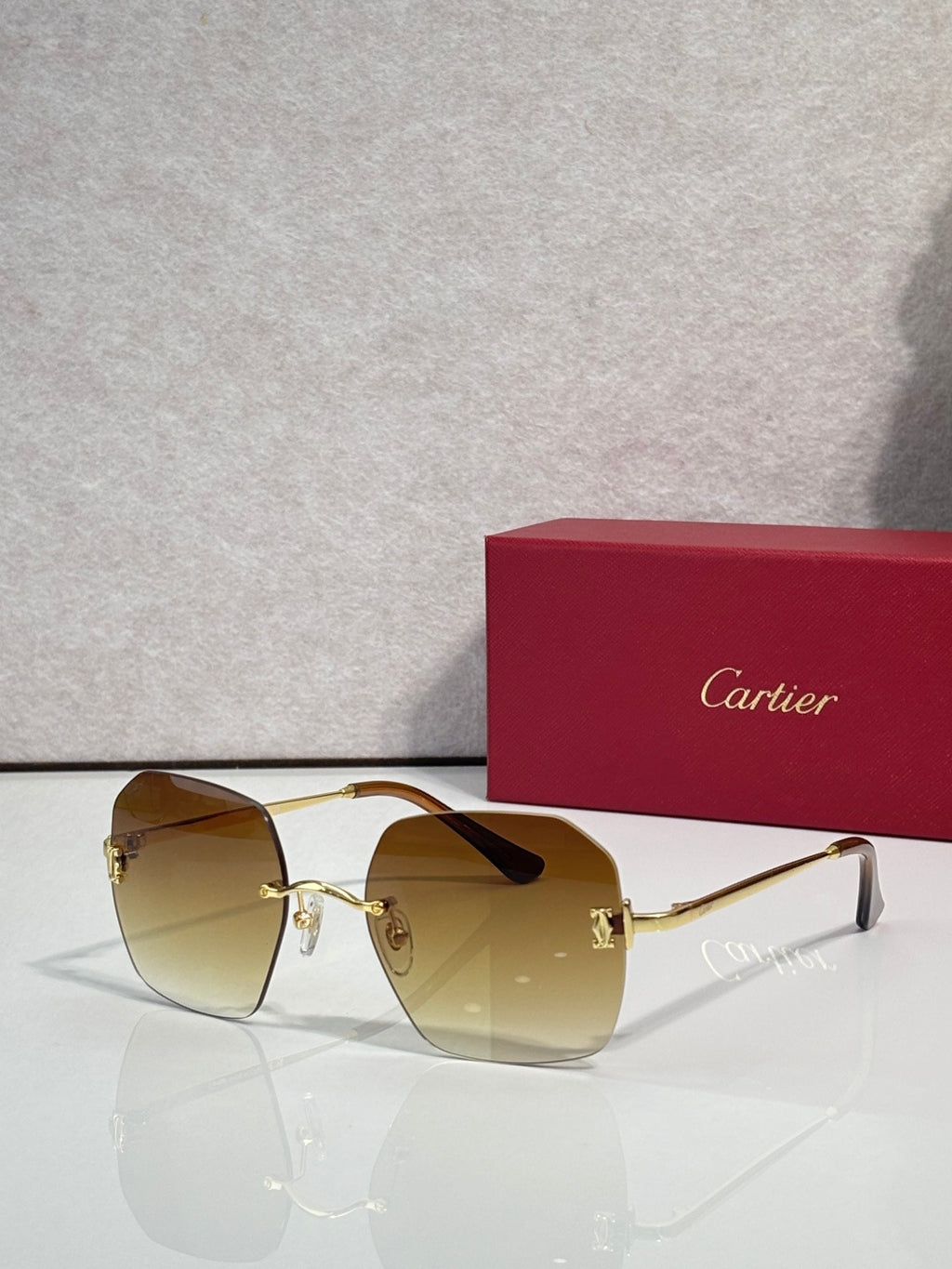 Gold-framed sunglasses with amber-tinted lenses and slim metal frame