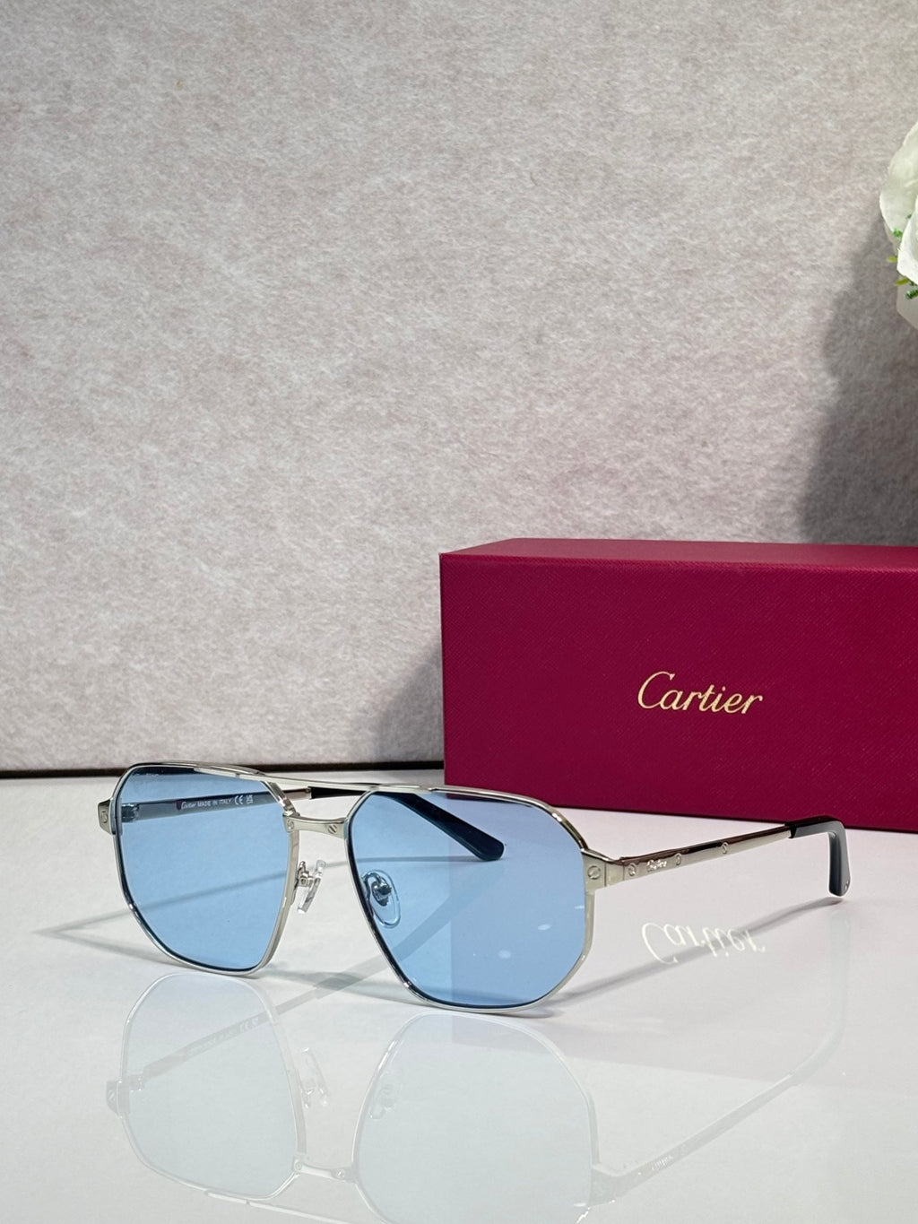 Cartier sunglasses with silver frames and light blue tinted lenses