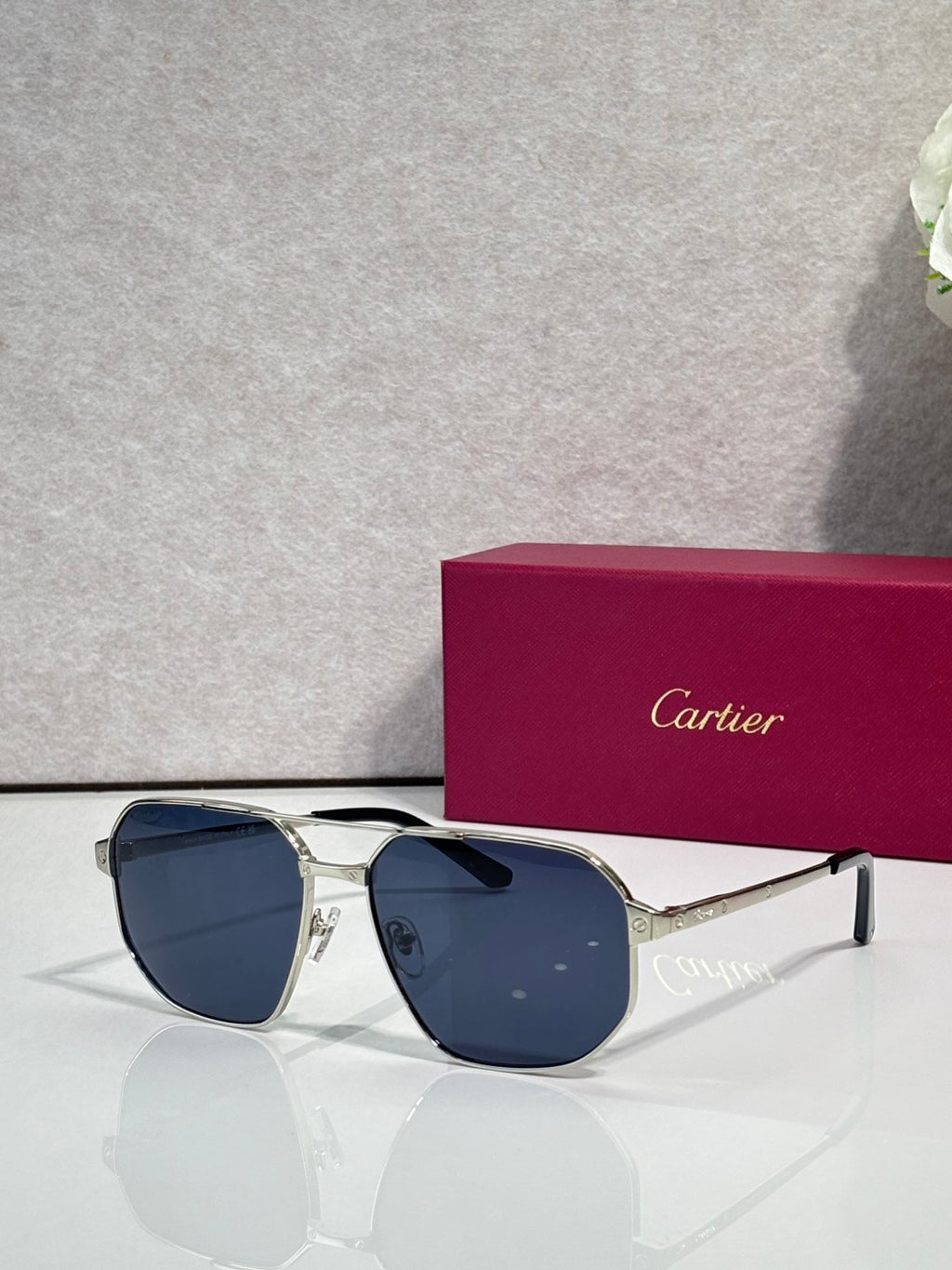 Cartier sunglasses with silver frames and dark blue tinted lenses