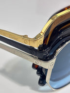 Cartier sunglasses close-up of gold frame with blue temple detail