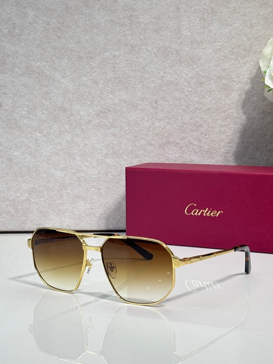 Cartier sunglasses with gold frames and amber tinted lenses
