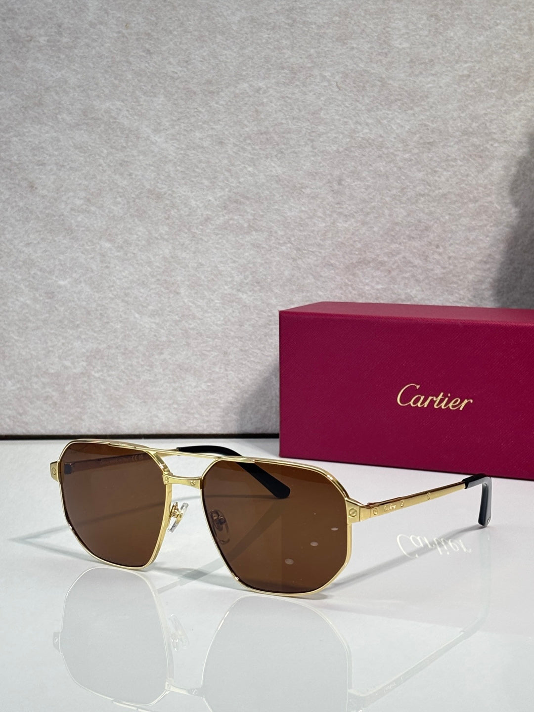 Cartier sunglasses with gold frames and brown tinted lenses