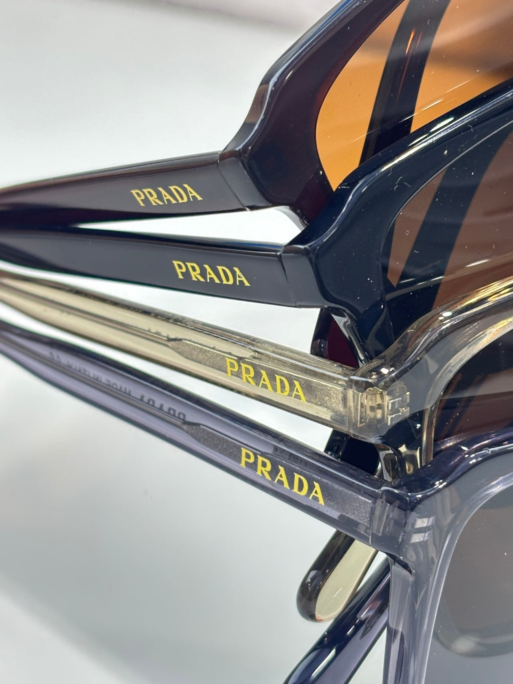 Close-up of dark navy sunglasses frame and Prada logo temple