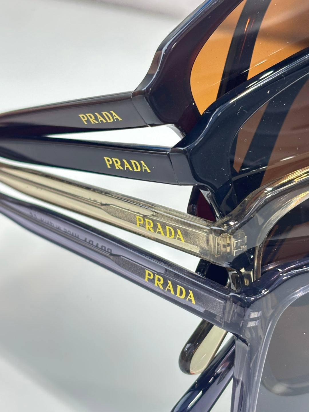Close-up of dark navy sunglasses frame and Prada logo temple
