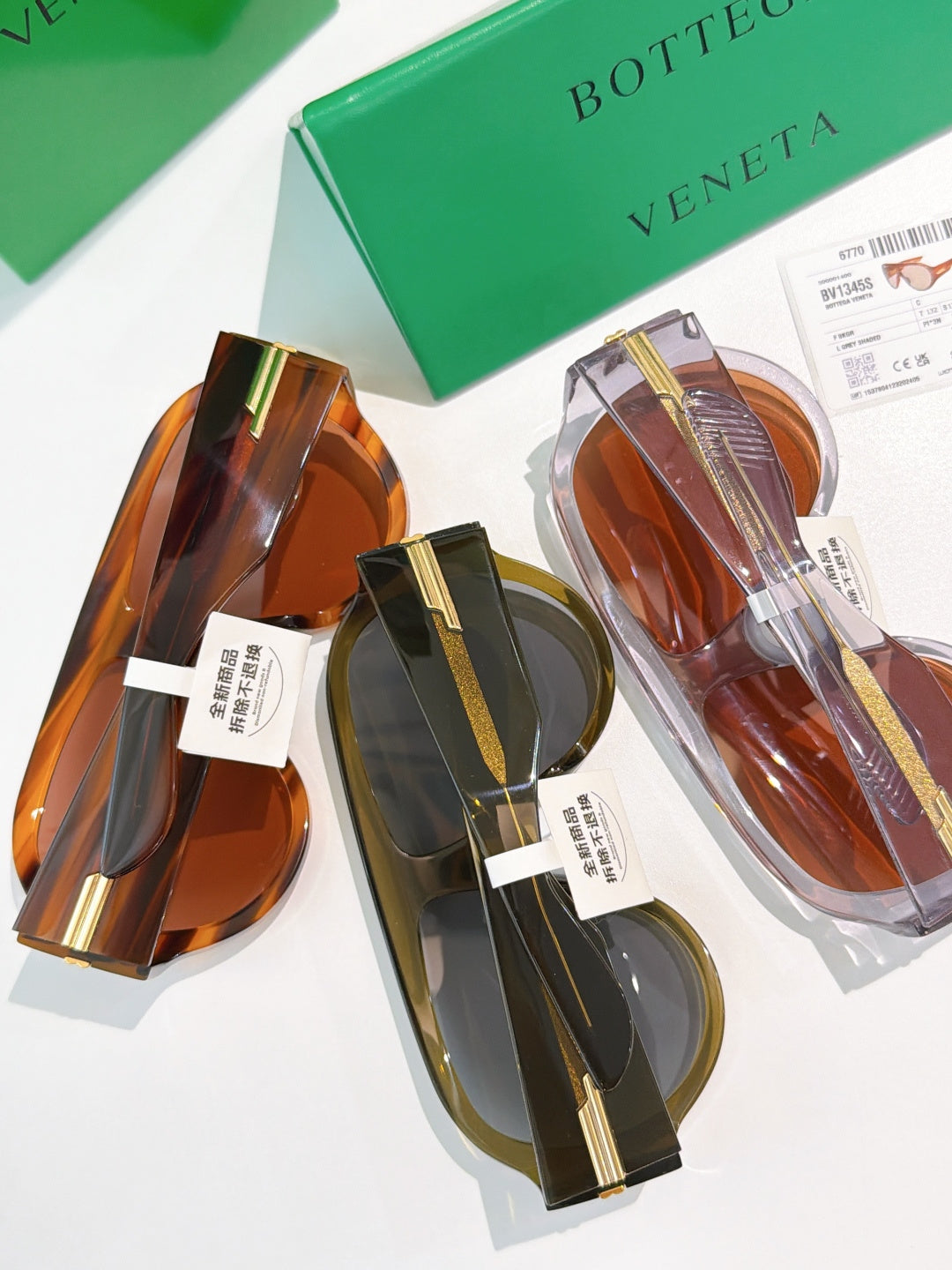 Bottega Veneta sunglasses assortment with gold accents in amber and olive tones