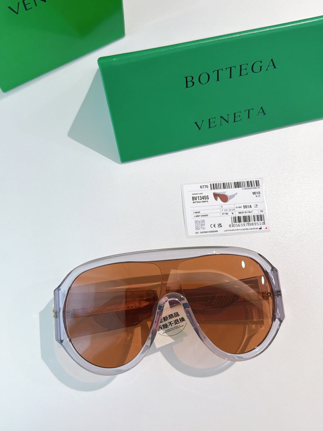 Bottega Veneta aviator sunglasses with silver-toned frames and amber lenses