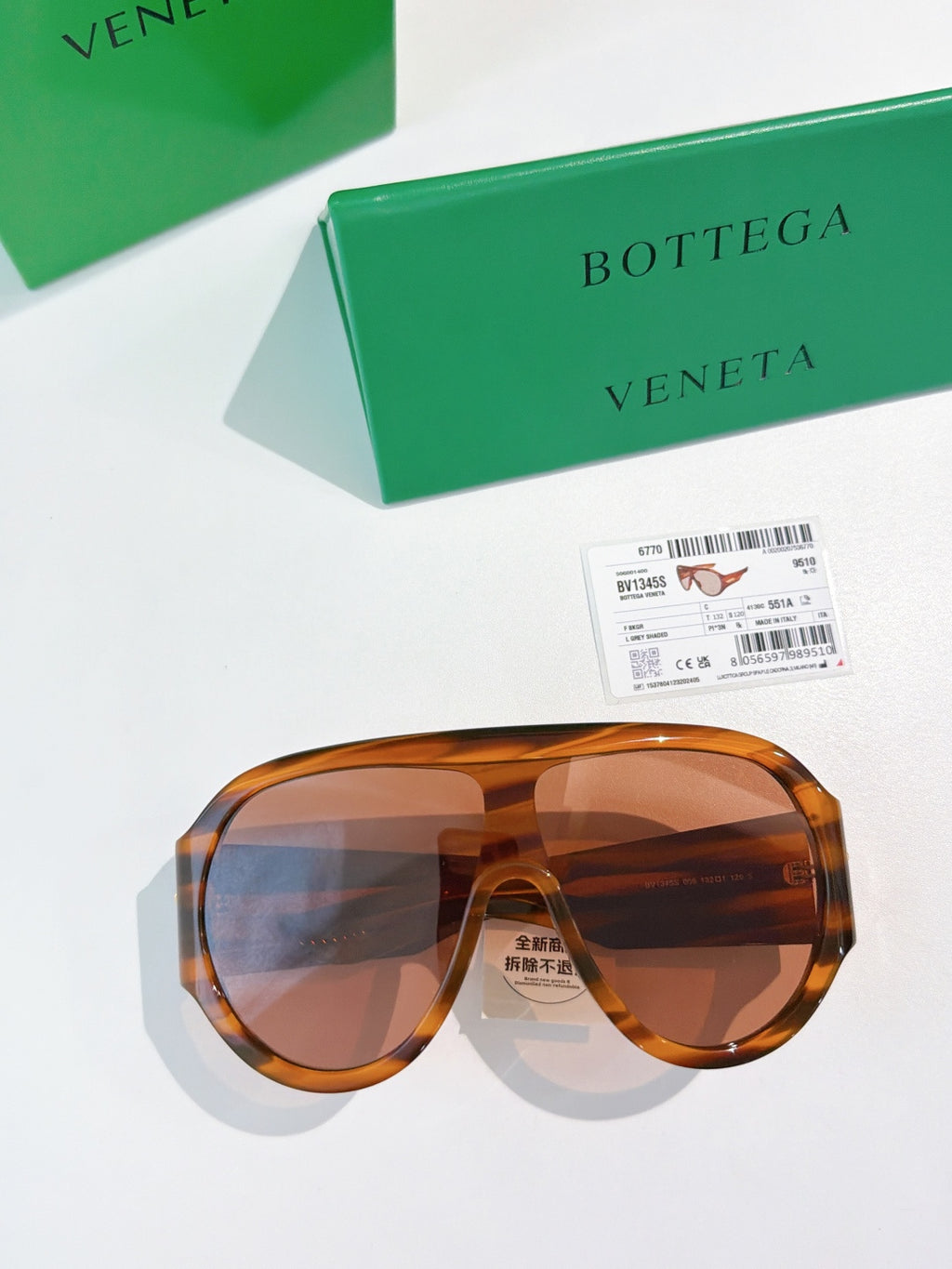 Bottega Veneta aviator sunglasses with translucent amber frames and brown lenses