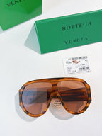 Bottega Veneta aviator sunglasses with translucent amber frames and brown lenses