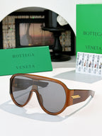 Bottega Veneta sunglasses with dark lenses and tortoiseshell frames, gold temple detail