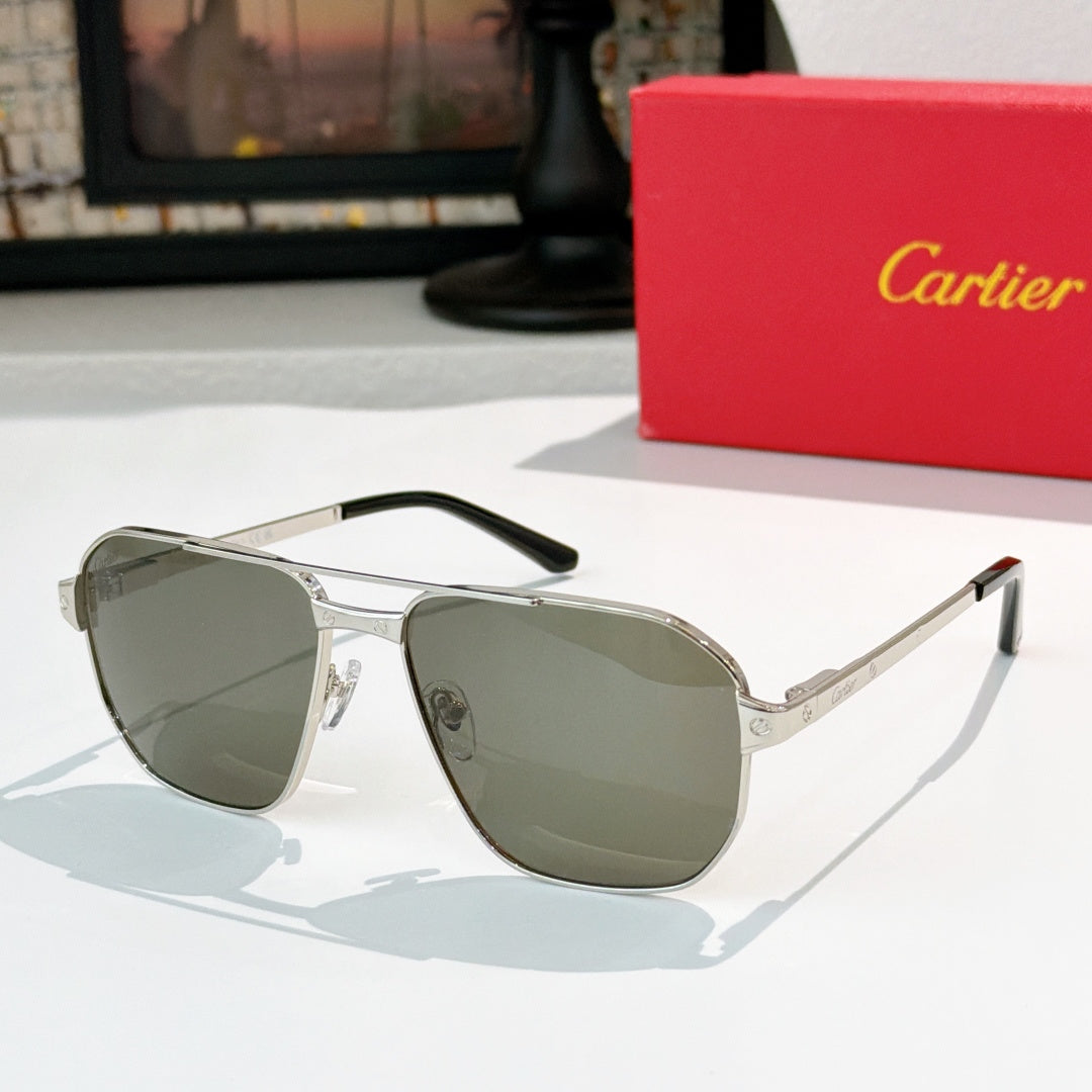 Cartier sunglasses with silver frame and muted green lenses, aviator style.