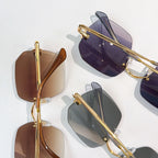 Assorted Cartier sunglasses with mixed tinted lenses and gold frames, overlapping