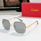 Cartier sunglasses with light gray tinted lenses and gold metal frame, front view