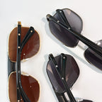 Cartier sunglasses with black and brown frames, dark tinted lenses, metal hinges.