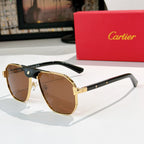 Cartier sunglasses with black frames, gold bridge, and brown gradient lenses.