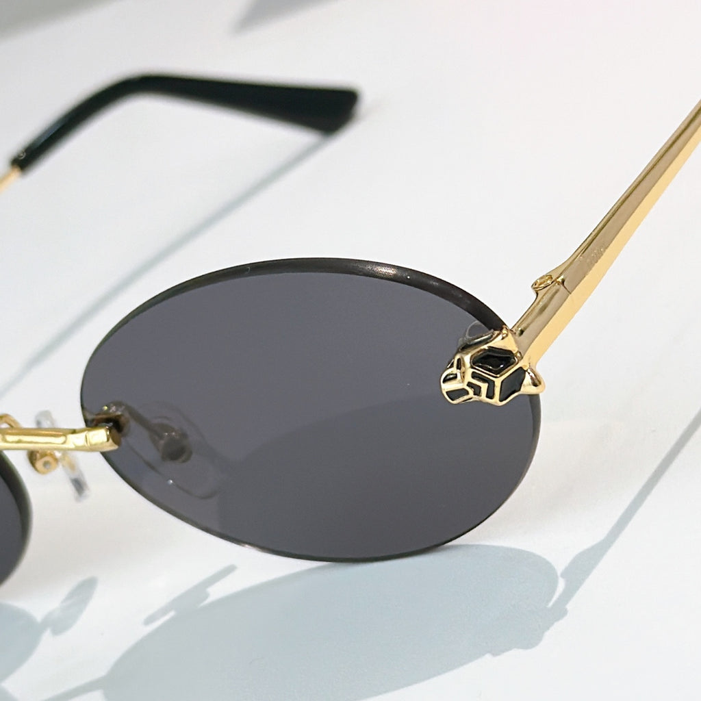 Close-up Cartier glasses with dark oval lenses and gold bridge detailing