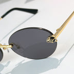 Close-up Cartier glasses with dark oval lenses and gold bridge detailing