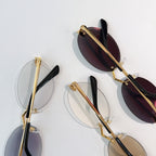 Cartier glasses with gold metal frame, dark maroon lenses, and black temple tips