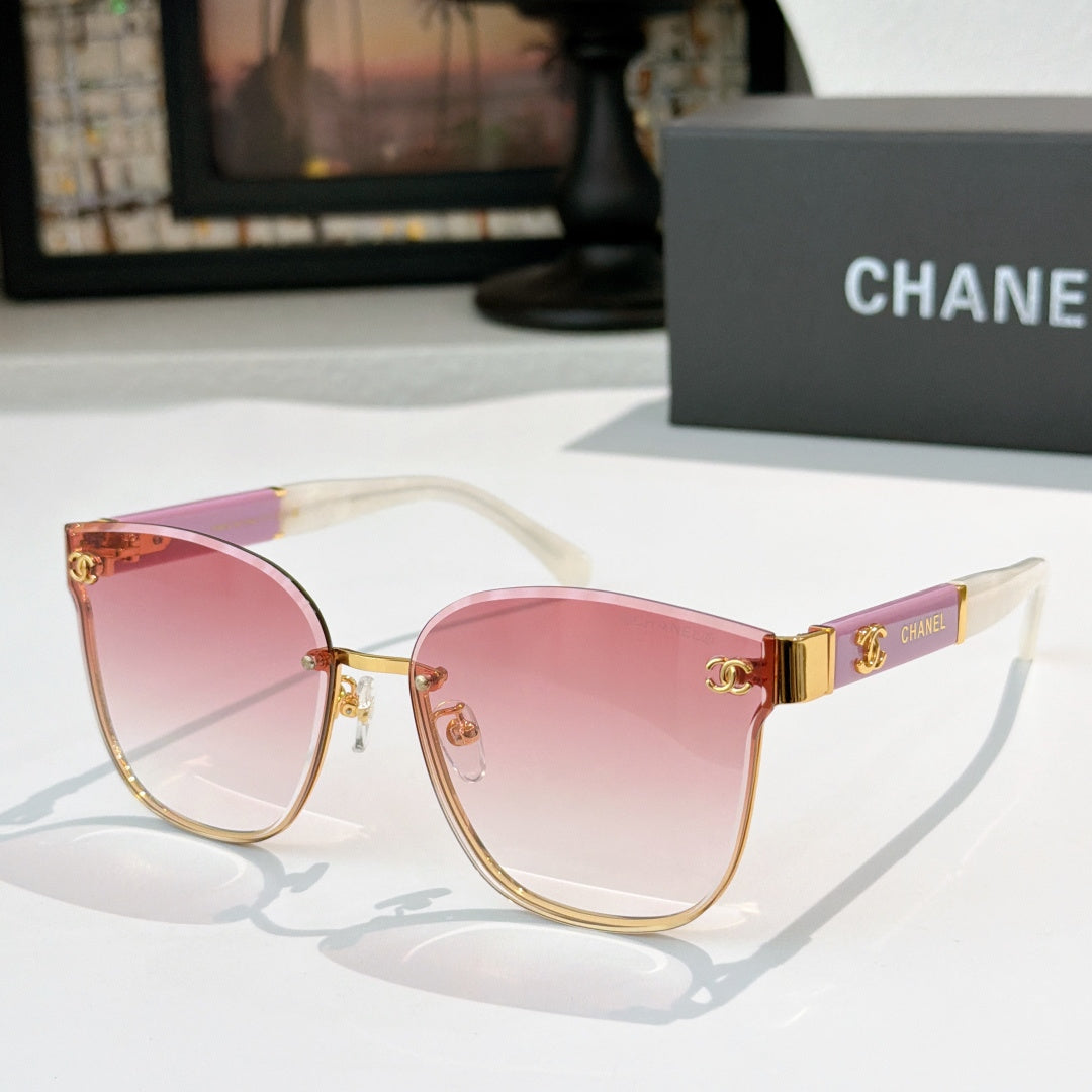 Chanel cat-eye sunglasses with pink tinted lenses, gold-tone frame and clear temples