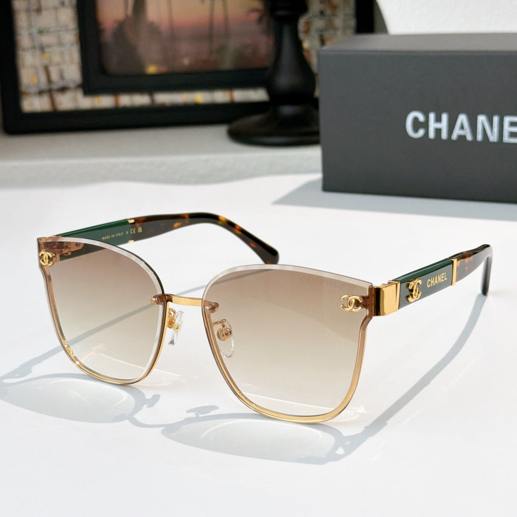 Chanel cat-eye sunglasses with light tinted lenses, gold-tone frame and patterned green temples