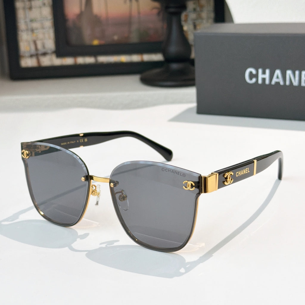 Chanel cat-eye sunglasses with dark gray lenses, gold-tone frame and black temples