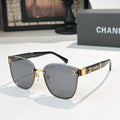 Chanel cat-eye sunglasses with dark gray lenses, gold-tone frame and black temples