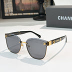 Chanel cat-eye sunglasses with dark gray lenses, gold-tone frame and black temples