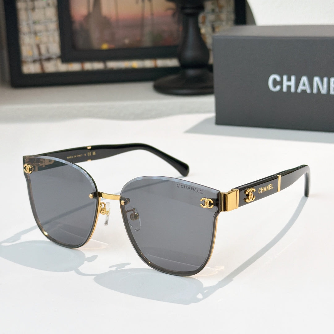 Chanel cat-eye sunglasses with dark gray lenses, gold-tone frame and black temples