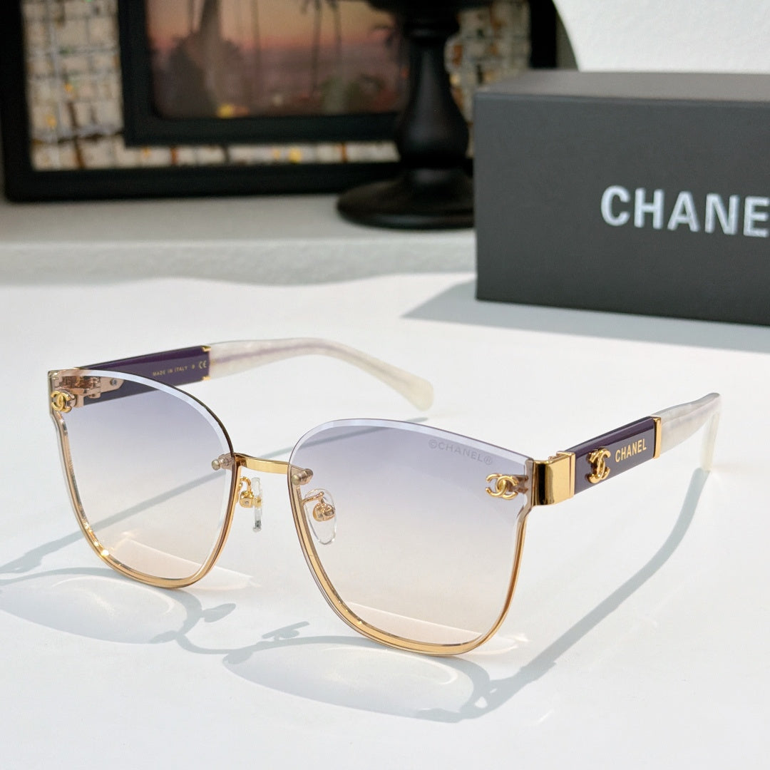 Chanel cat-eye sunglasses with light blue-gray lenses, gold-tone frame and clear temples