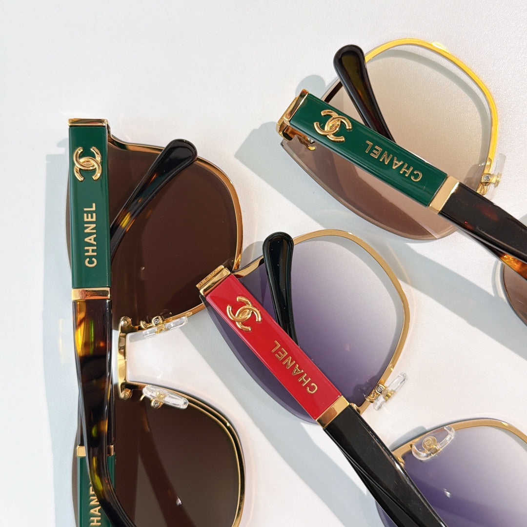 Chanel sunglasses with dark brown and purple lenses, gold-tone frames and striped temples