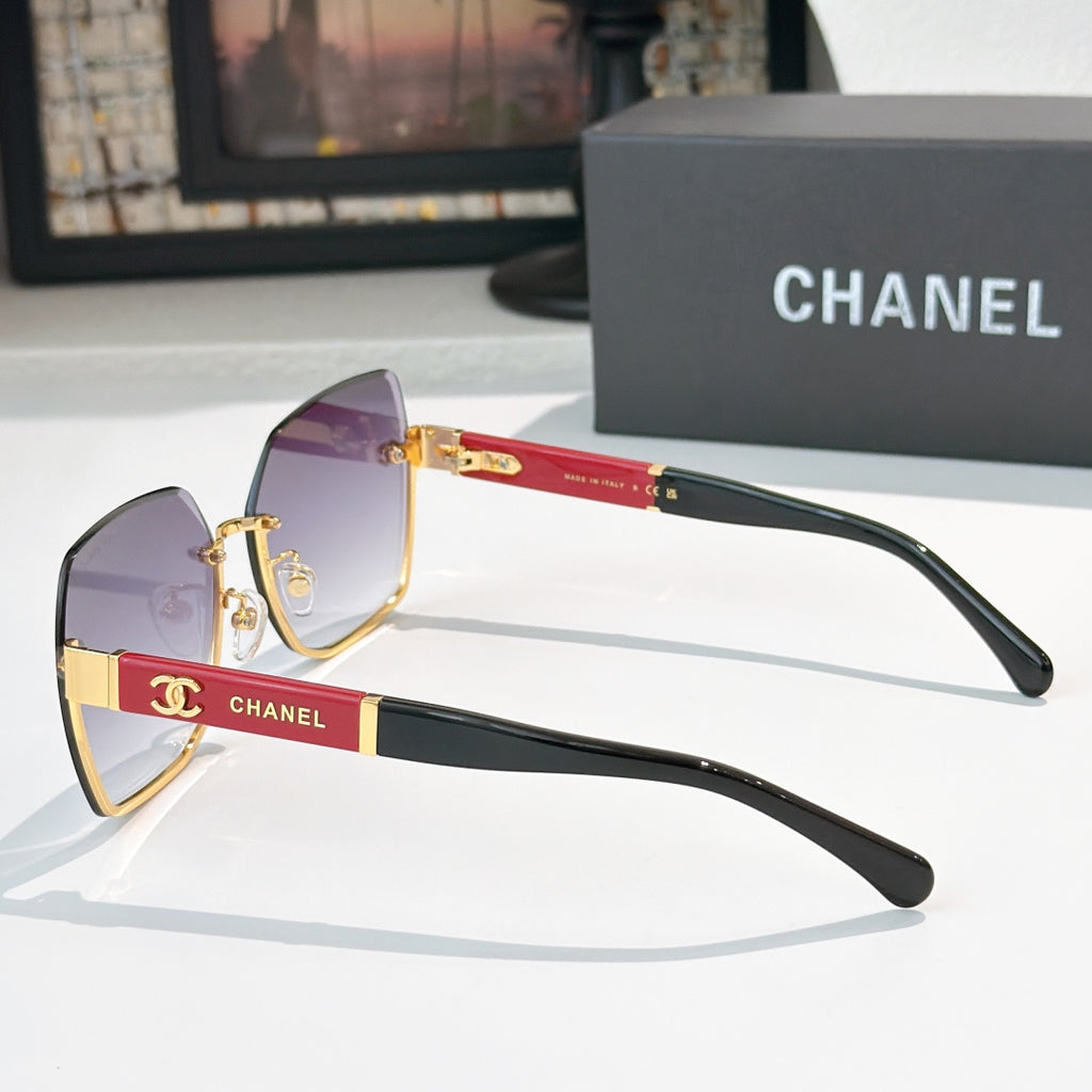 Cat-eye sunglasses with violet lenses, black temples, and gold-tone details