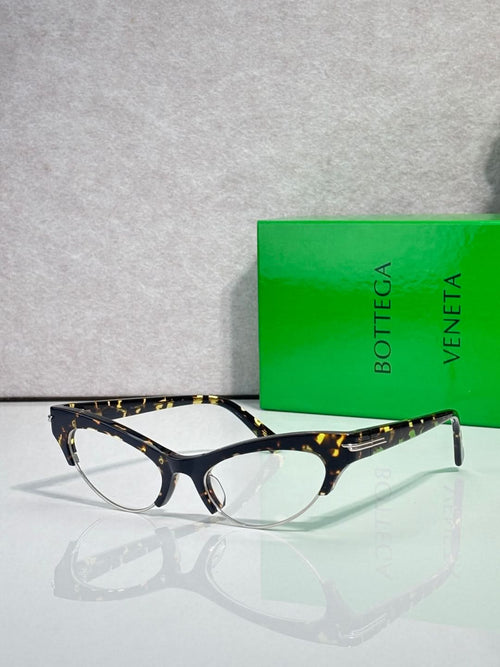 Bottega Veneta glasses with tortoiseshell front, dark temples, and clear lenses