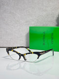 Bottega Veneta glasses with dark tortoiseshell frames and clear lenses
