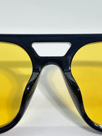 Dark blue eyeglass frames with yellow-tinted lenses